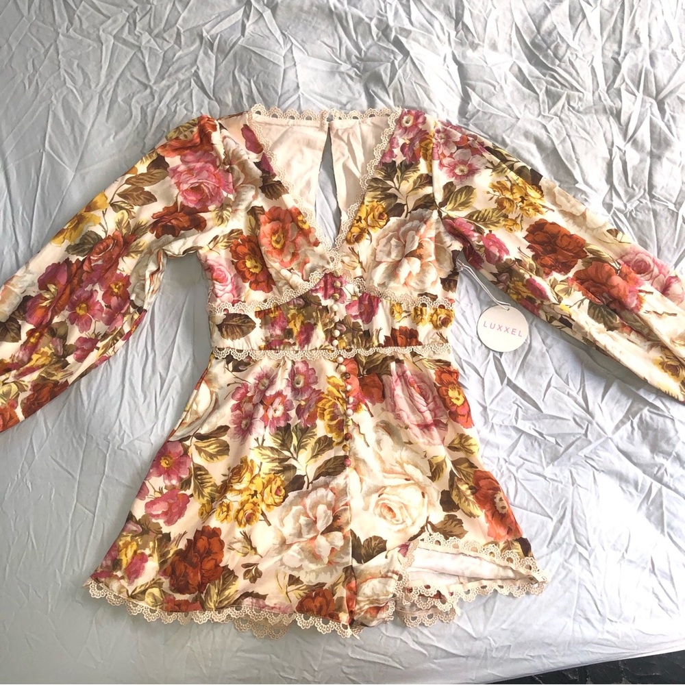 Runs small pretty hippie romper never worn.